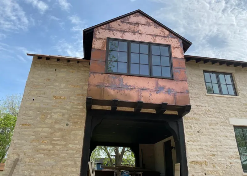 Copper metal panel facade on a stone building for Skylight Installation in Broomfield